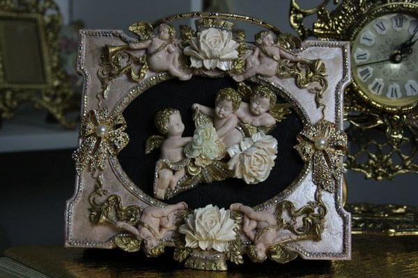 A picture frame with angels on it
