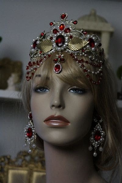 A mannequin wearing jewelry and a crown.