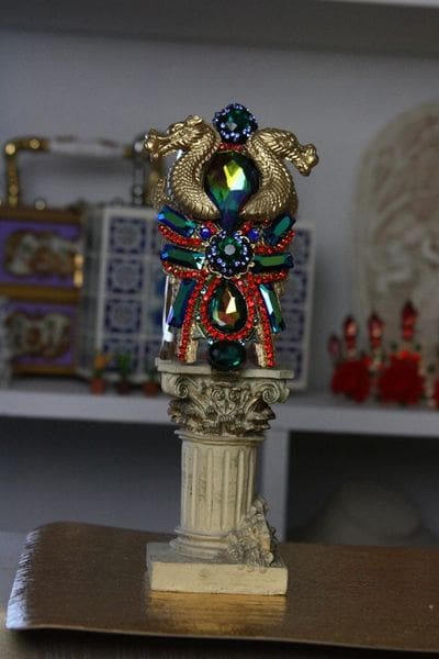 A statue of a person with colorful jewelry on it.