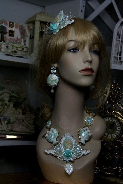 A mannequin wearing jewelry and earrings in a room.