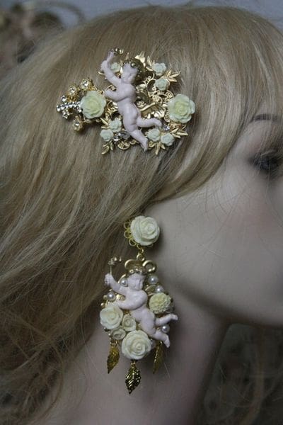 A woman with blonde hair and pink angel earrings.