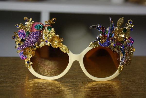 A pair of sunglasses with some jewels on them