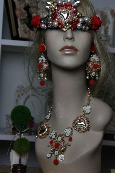 A mannequin wearing jewelry and a hat.