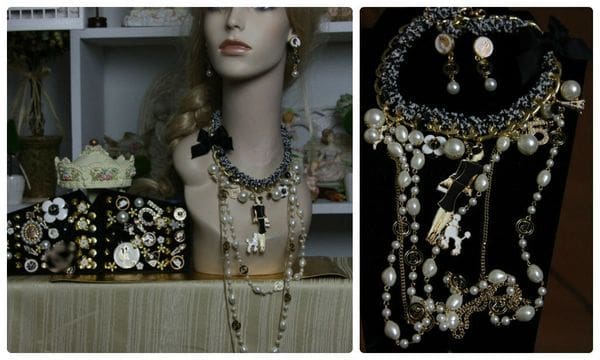 A mannequin wearing jewelry and earrings in front of a display.
