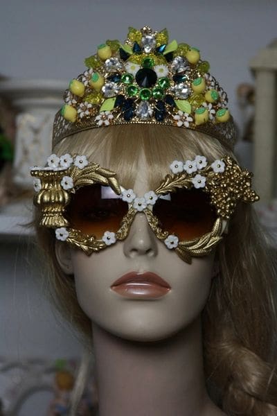 A mannequin wearing sunglasses and a crown.