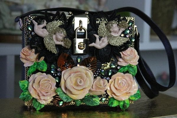 A purse with flowers and butterflies on it.