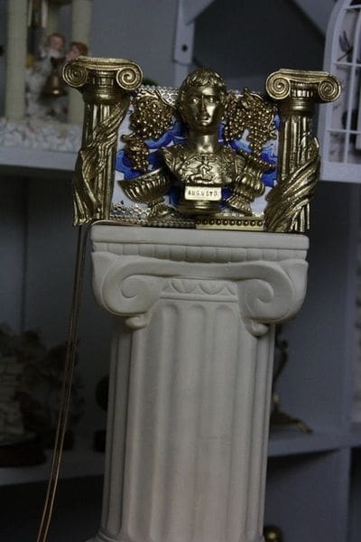 A statue of an elephant with a gold and blue decoration.