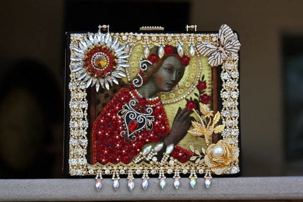 A red purse with a woman in the middle of it.