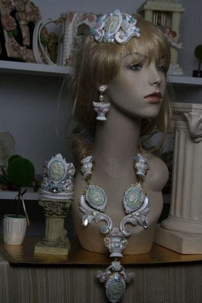 A mannequin wearing jewelry and earrings in a room.