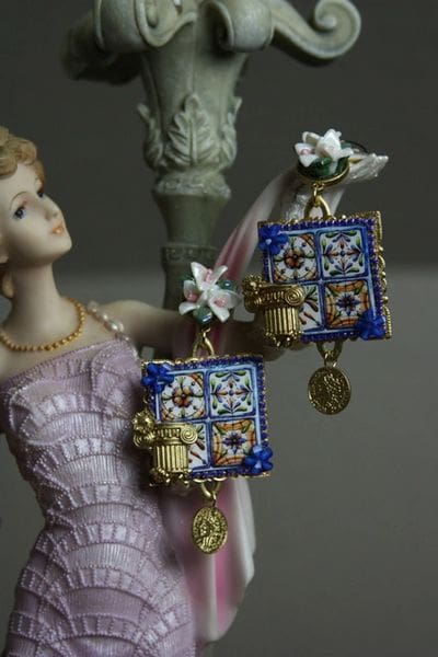 A statue of a woman holding a blue purse.
