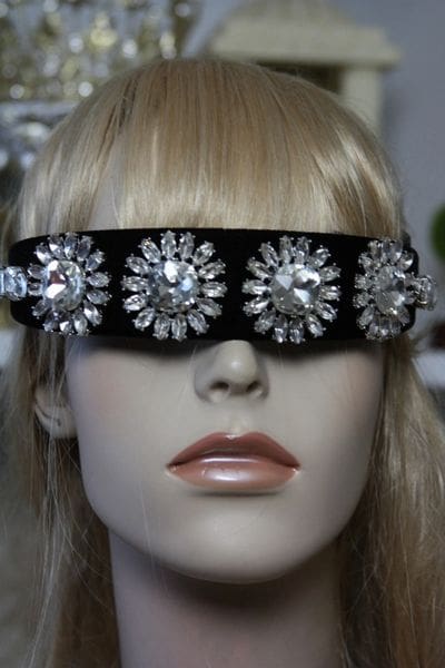 A mannequin wearing sunglasses with jewels on them.