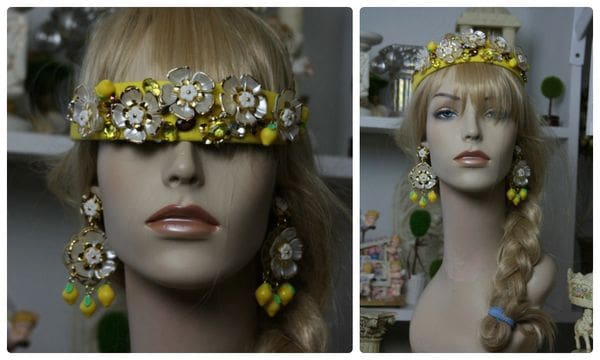 A mannequin wearing a headpiece and earrings.