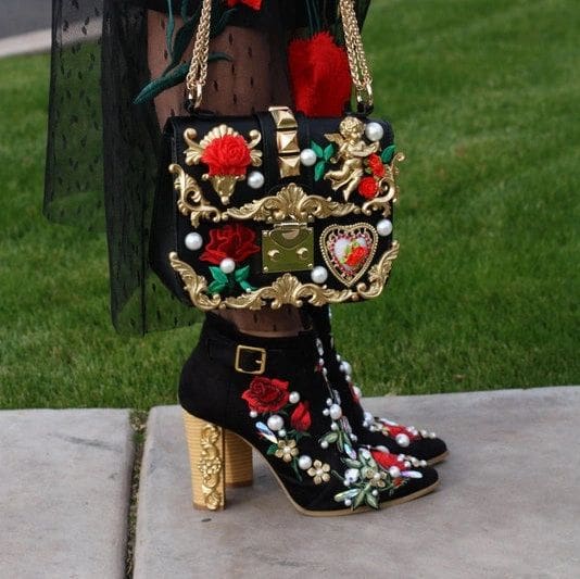 A woman wearing high heels and holding onto her purse