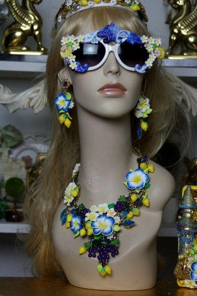 A mannequin wearing sunglasses and a necklace.