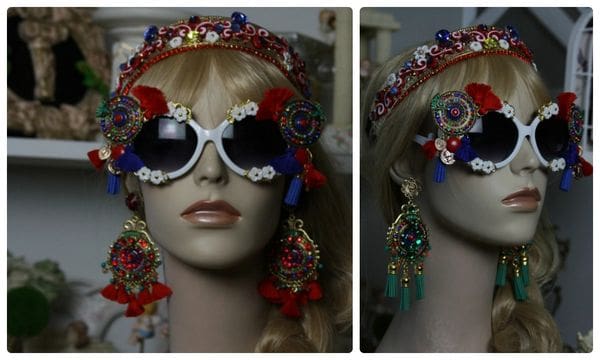 A woman wearing sunglasses and a headpiece.