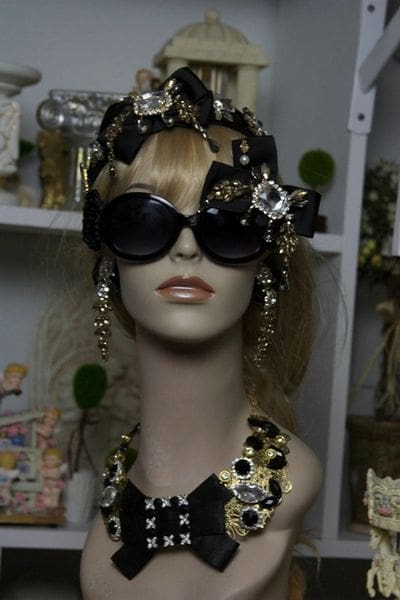 A mannequin wearing sunglasses and a head piece.