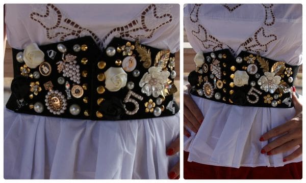 A woman wearing a black and white dress with buttons on it.