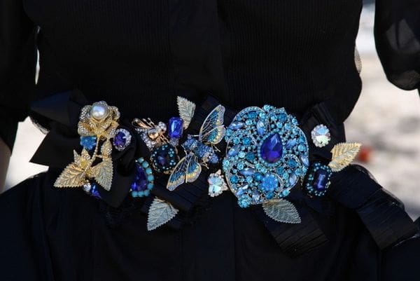 A black fabric with blue and gold flowers