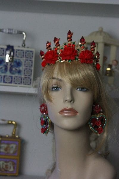 A mannequin wearing a crown and earrings.