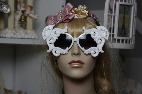 A mannequin wearing sunglasses and a headband.