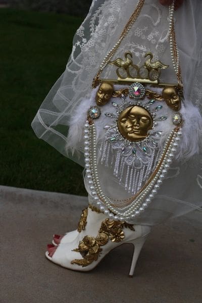 A close up of the head and face on a wedding dress