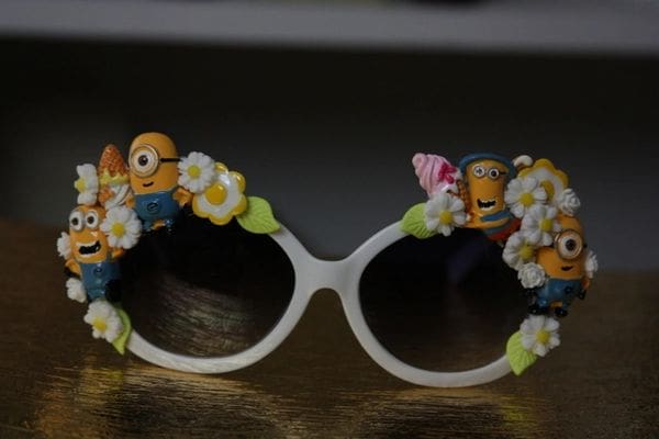 A pair of sunglasses with flowers and minions on them.
