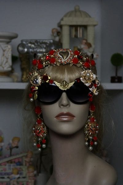 A mannequin wearing sunglasses and a head piece.