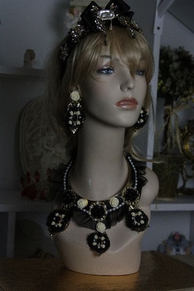 A mannequin wearing jewelry and earrings in a room.