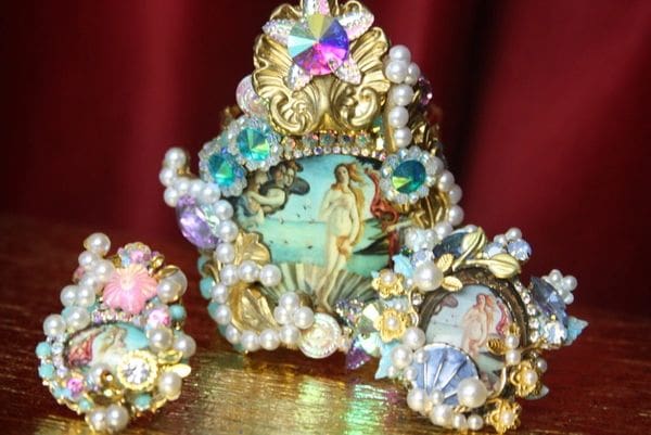 A set of three pieces of jewelry with pearls and stones.