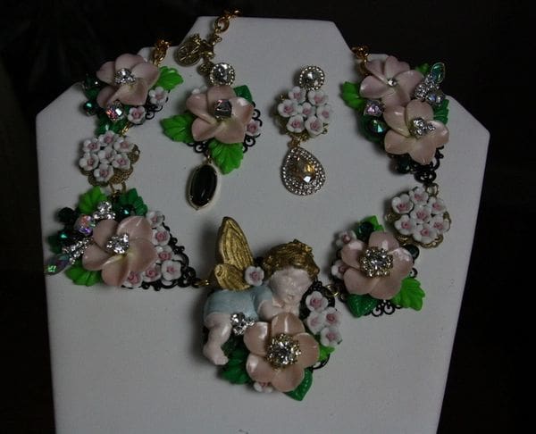 A necklace and earrings set with flowers on it.