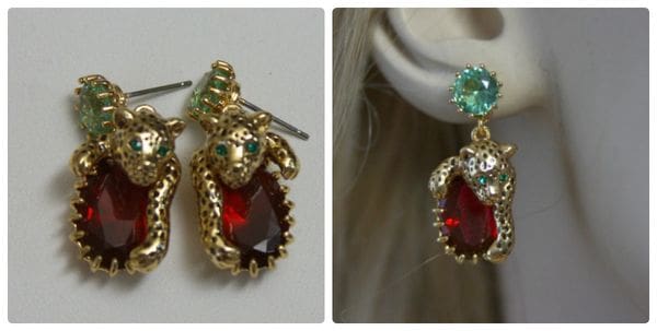 A pair of earrings with red and green stones.