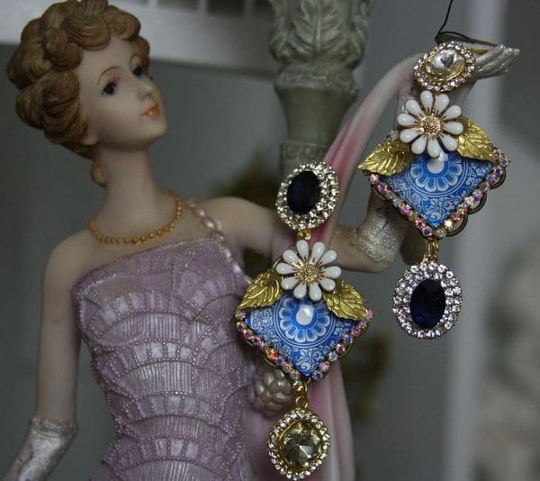 A woman in pink dress holding up some jewelry.