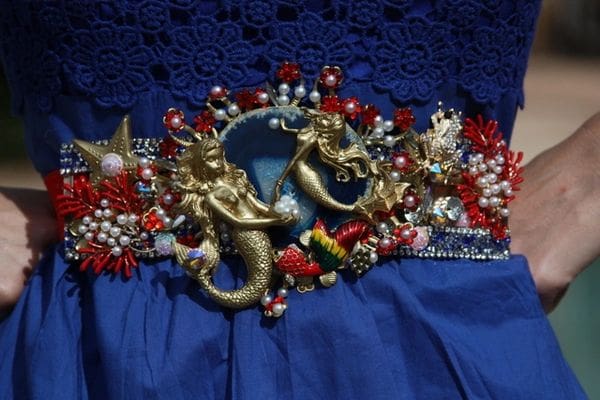 A blue skirt with some gold seahorses and red flowers