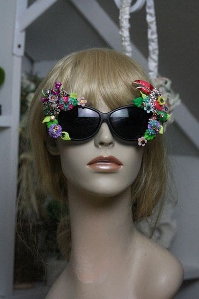 A mannequin wearing sunglasses with flowers on them.