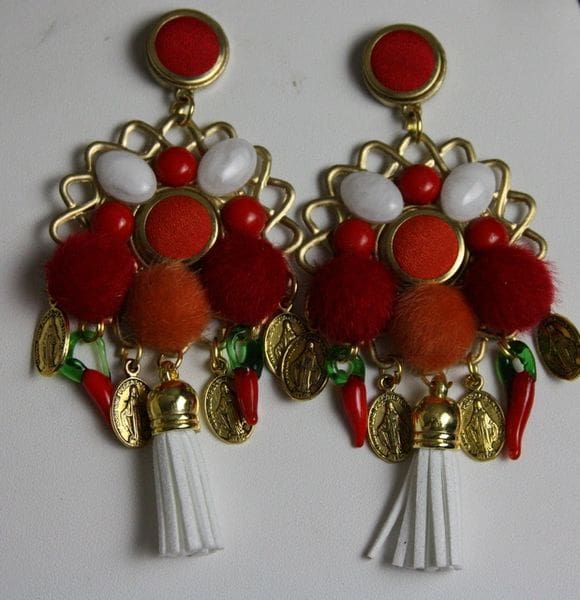 A pair of earrings with red and white beads.