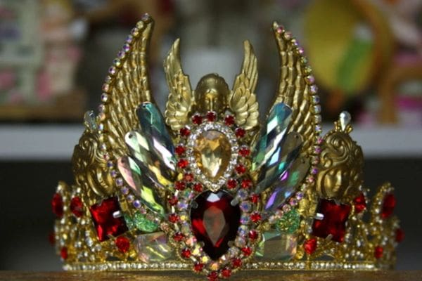 A close up of the crown with red jewels