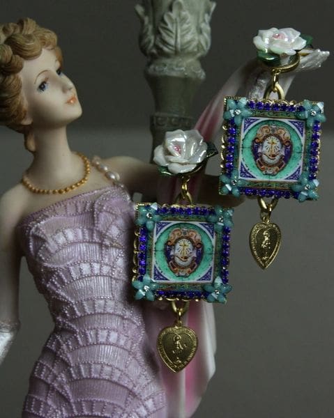 A statue of a woman in a purple dress and two earrings.