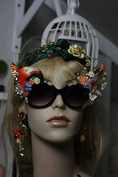 A mannequin wearing sunglasses and a headpiece.