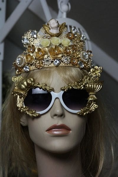 A mannequin wearing sunglasses and a crown.