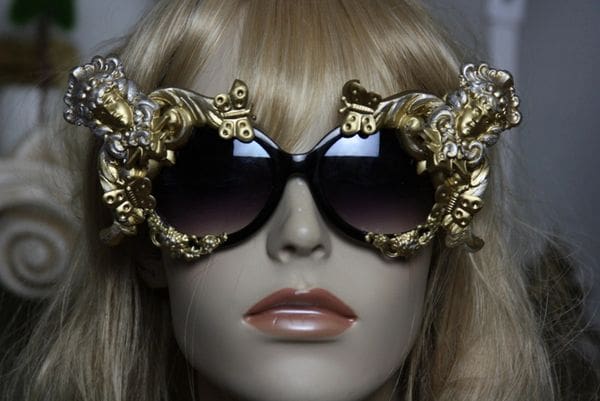 A mannequin wearing sunglasses with gold embellishments.
