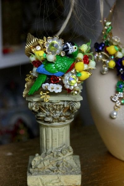 A close up of some jewelry on top of a statue