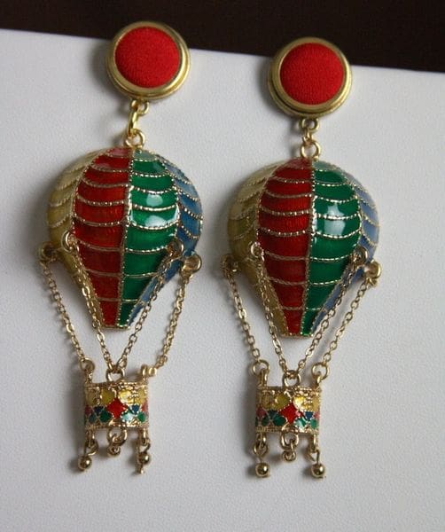 A pair of earrings with red and green balloons.