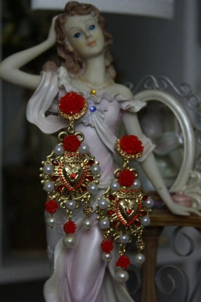 A statue of a woman wearing red and gold jewelry.