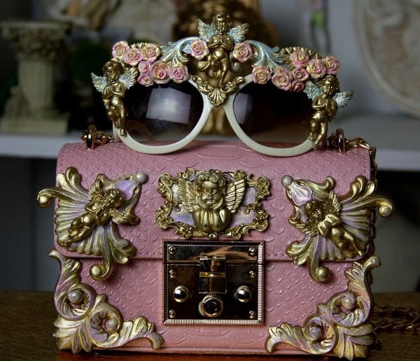 A pink box with gold and white decorations on it.