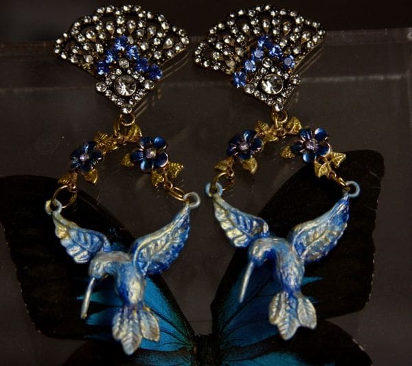 A pair of blue and white hummingbird earrings.