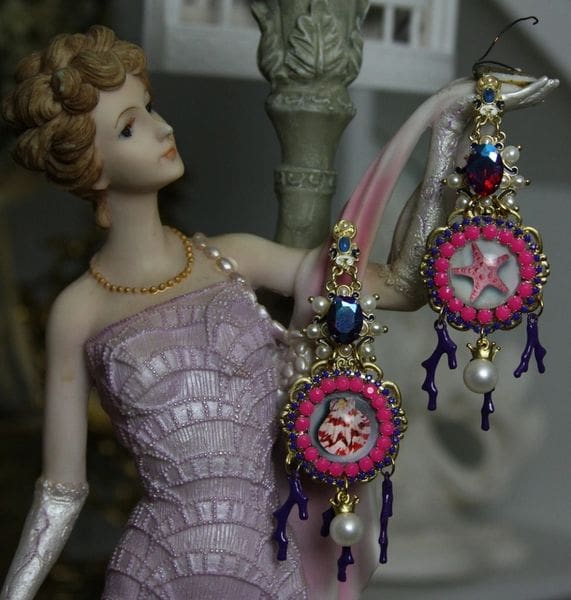 A doll wearing earrings and a dress
