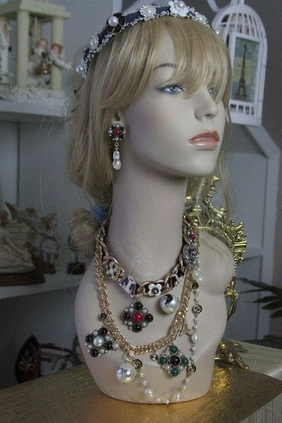 A mannequin wearing jewelry and earrings in a store.