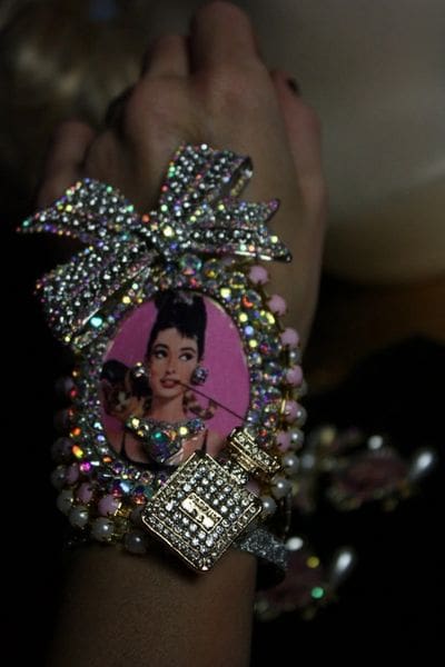 A person holding onto a picture of a woman