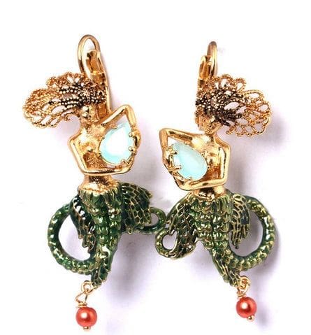 A pair of earrings with green and red stones.