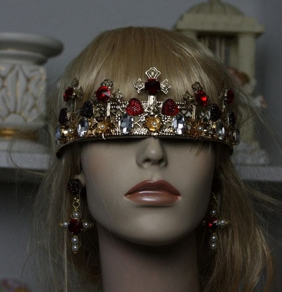 A mannequin wearing a crown and earrings.